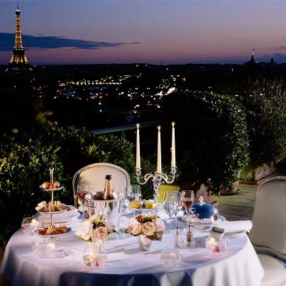 Who We Are image 2 table w Eiffel Tower view from Le Meurice