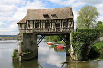 Raised Normandy half-timbre house over water, seen on Normandy vacation packages tour 